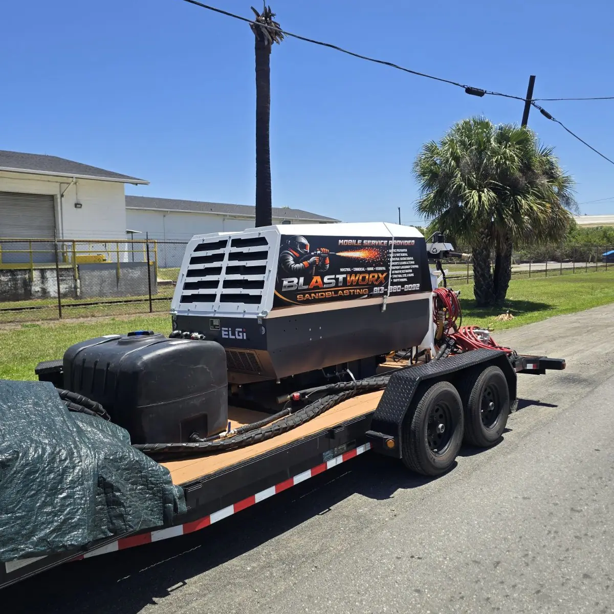 Blastworx mobile blasting rig and air compressor loaded on a trailer, ready for a job in Tampa Bay