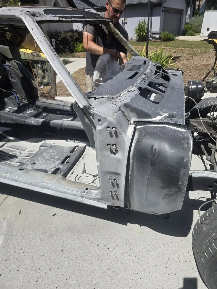 Classic project car body shell stripped to clean bare metal after blasting