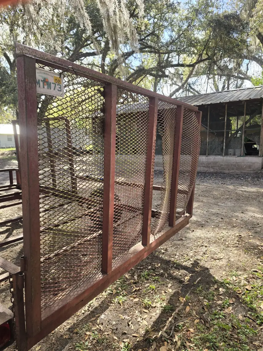 Rusted utility trailer with a corroded frame before blasting