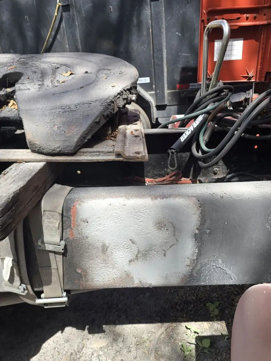 Greasy, corroded fleet truck chassis before blasting